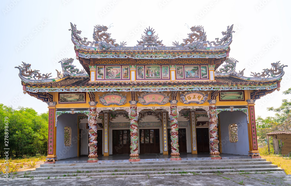 Obraz premium The ancient house with elaborate carved columns of pottery is a typical culture in Ke Vo cultural village, Hue, Vietnam.