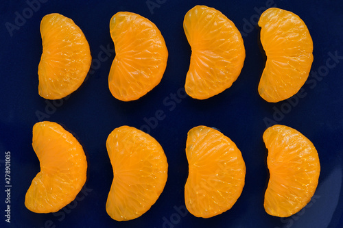 Mandarin orange fruits isolated on dark blue background