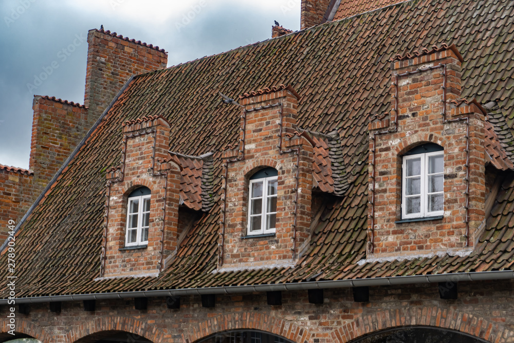 Gable with small lattice windows in a historic building in Lübeck, Germany