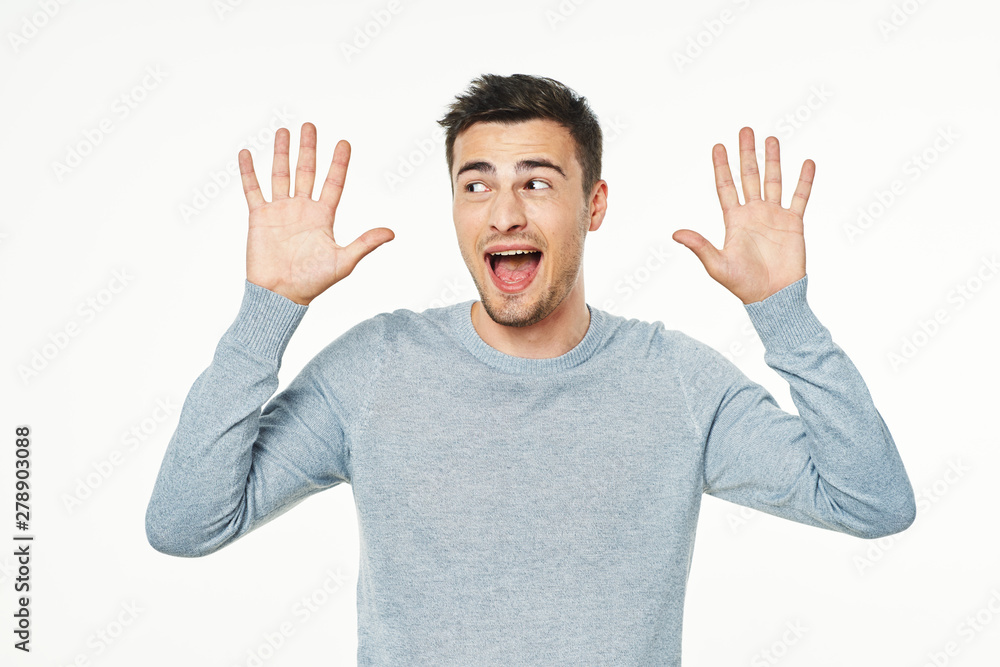 young man with hands up young man with hands up