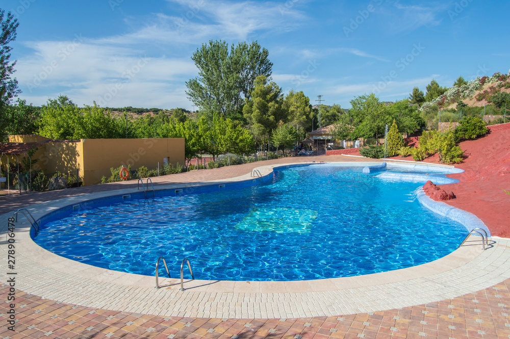 Outdoor pool with natural landscape background in a place of Albacete. Castilla La Mancha. Spain