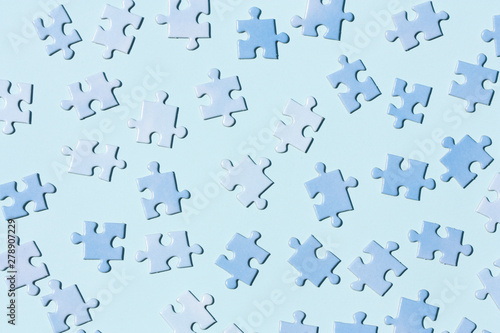 Puzzle pieces on a light blue background.