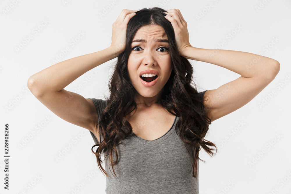 Beautiful confused displeased young woman posing isolated over white wall background. Beautiful confused displeased young woman posing isolated over white wall background.