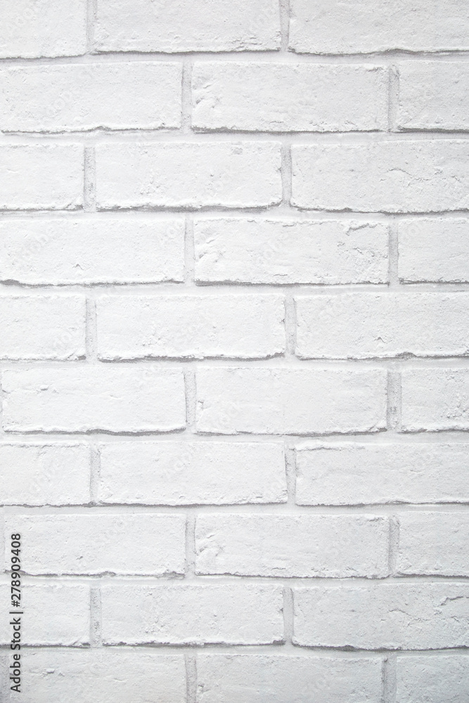 White painted brick wall in a vertical format - backgrounds and textures White painted brick wall in a vertical format - backgrounds and textures