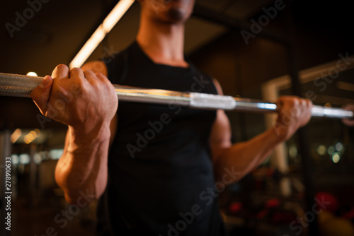 Athletic man playing dumbbell exercise for arm endurance training exercise to strengthen and tone the shoulder muscles. concept of weight training.