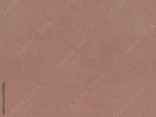 Textured plaster in terracotta color. High resolution seamless texture of stucco for background, pattern, poster, collage, gift wrap, wallpaper, photo layering etc. photo