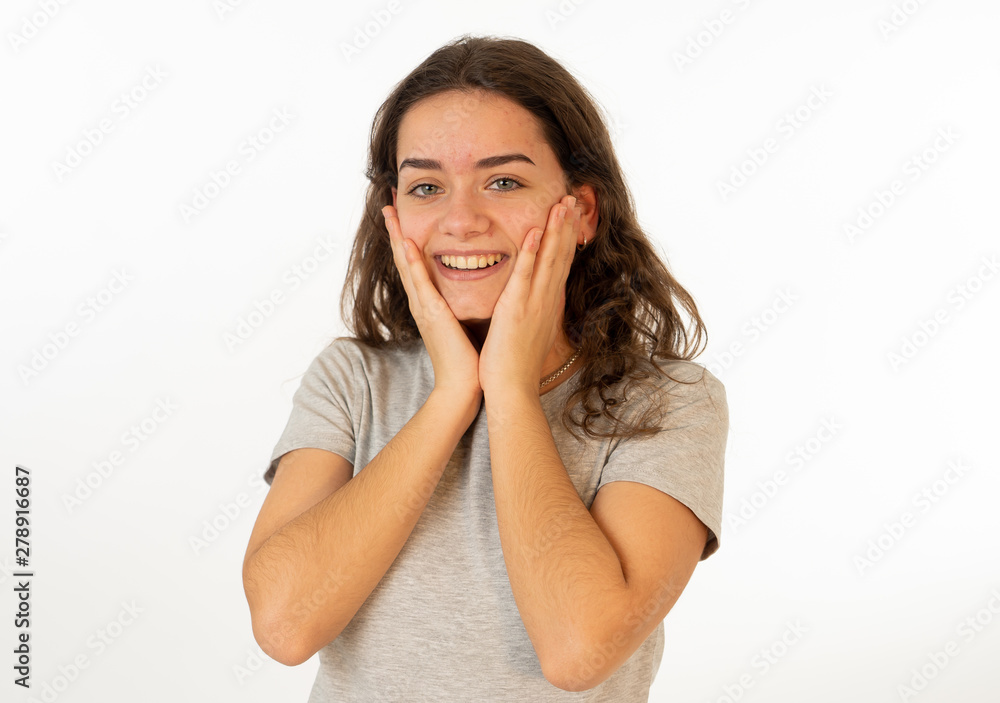 Human expressions and emotions. Portrait of young attractive girl smiling with surprised happy face Human expressions and emotions. Portrait of young attractive girl smiling with surprised happy face
