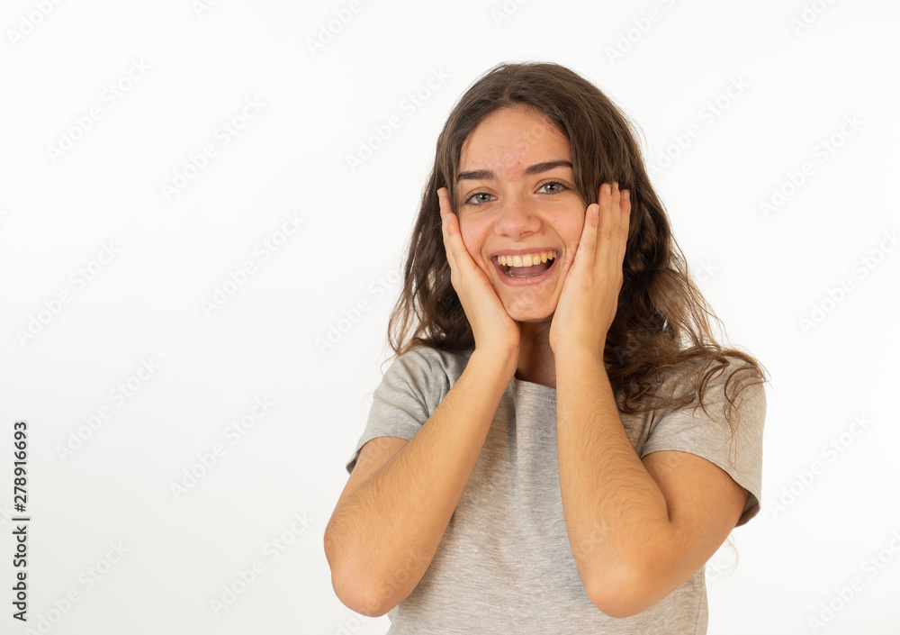 Human expressions and emotions. Portrait of young attractive girl smiling with surprised happy face Human expressions and emotions. Portrait of young attractive girl smiling with surprised happy face