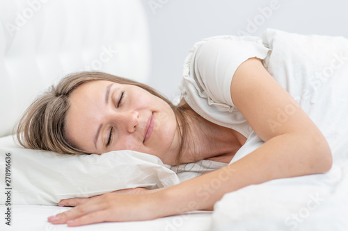 Beautiful girl sleeps in the bedroom at home