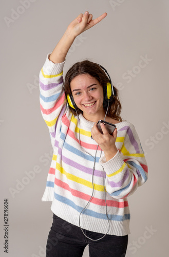 Pretty young teenager girl in headphones listening to music on m © SB Arts Media