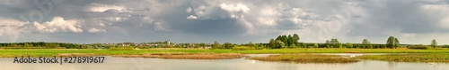 Panorama of landscape with river and blue sky.