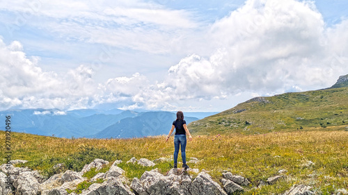 Mountain Chatyr Dag, Crimea. Tourist standing back over beautiful view on mountains and blue sky in summer.
