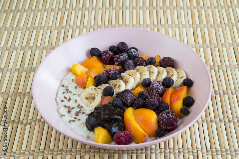 Oatmeal with bananas, apricots, blueberries, blackberries, chocolate paste and sesame seeds Oatmeal with bananas, apricots, blueberries, blackberries, chocolate paste and sesame seeds