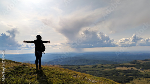 Mountain Chatyr Dag, Crimea. Tourist standing back over beautiful view on mountains and blue sky in summer.