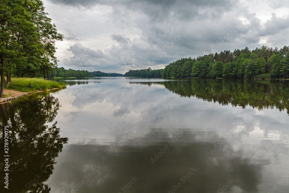 Reflection of moody sky in calm lake Reflection of moody sky in calm lake