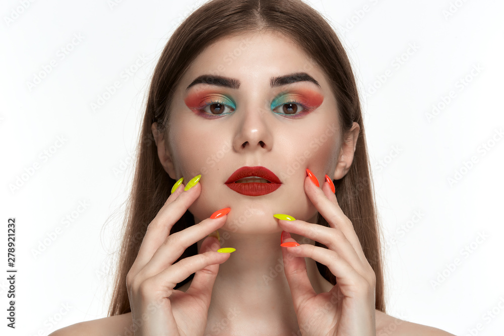 Closeup portrait of beautiful young woman with bright color make-up and manicure Closeup portrait of beautiful young woman with bright color make-up and manicure
