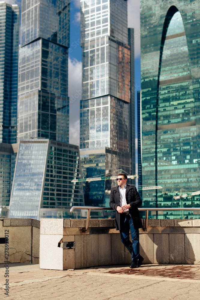 stylish young male businessman on the background of the cityscape