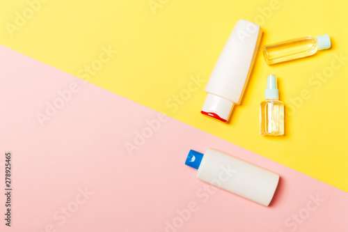 Group of plastic bodycare bottle Flat lay composition with cosmetic products on yellow and pink background empty space for you design. Set of White Cosmetic containers, top view with copy space