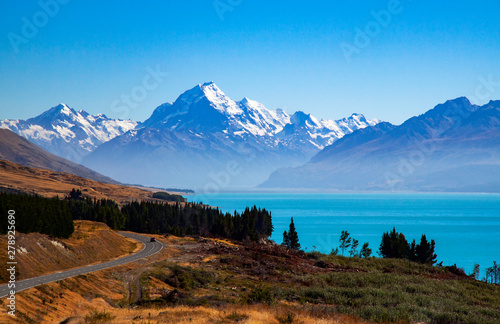 Iconic shot of Mount Cook in New Zealand showing the scenic road in  that passes along the shores of the beautiful Lake Pukaki.