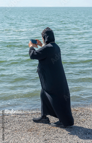 Tabgha, Israel - May 18 2019 : Coptic monk at the church in Tabgha beside Sea of Galilee
