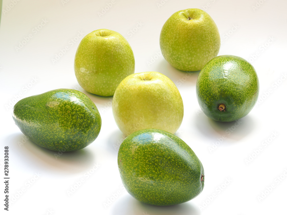 green apples and an avocado on a white background. green apples and an avocado on a white background.