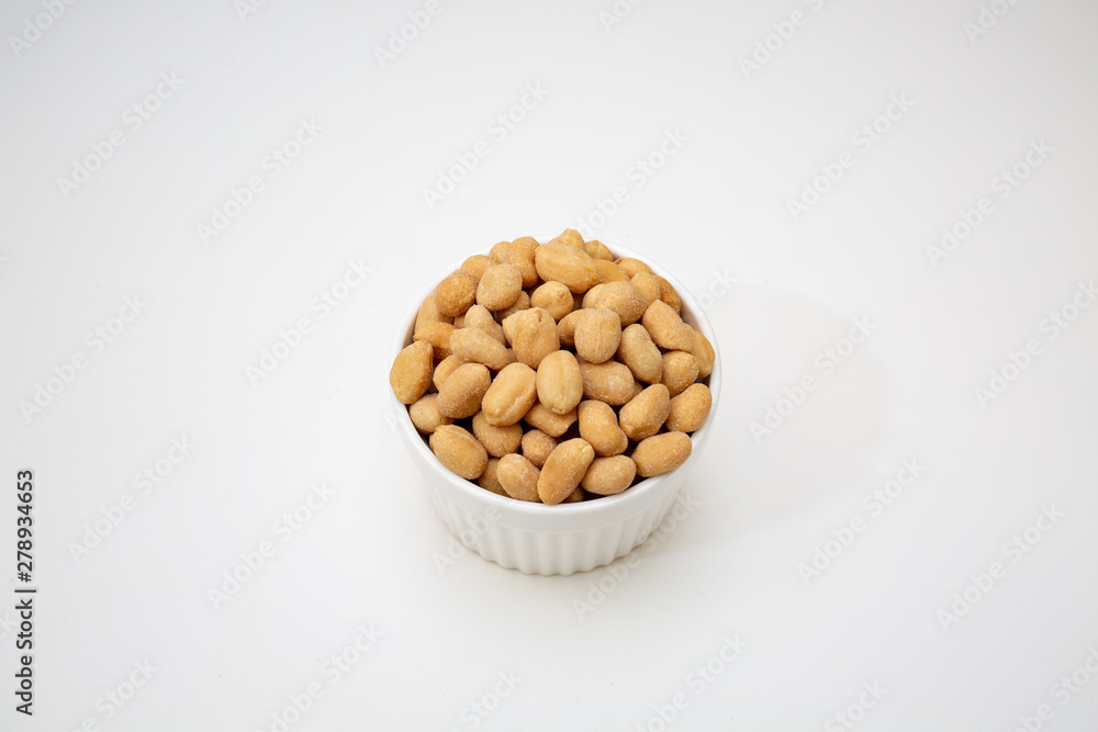 peanuts in a bowl isolated on white background peanuts in a bowl isolated on white background