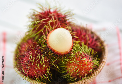 Rambutan peeled in a basket on table background - Fresh rambutan summer fruit from garden in Thailand