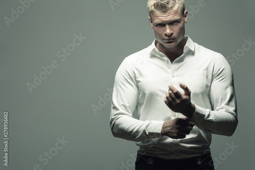 Male fashion, beauty concept. Portrait of brutal young man with short wet blond  hair wearing white shirt, posing over gray background. Classic style.  Copy-space. Studio shot Stock Photo | Adobe Stock