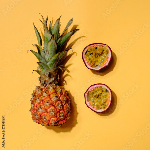 Creative layout made of pineapple and passion fruit. Flat lay. Food concept. Colorful fruit pattern.