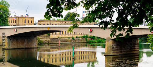 Panorama. Building with reflection in water, bridge over river Moselle. Thionville, France photo