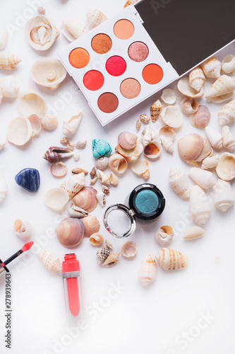 fashion summer coral eye palettes with natural shells and gemstones around background. close up