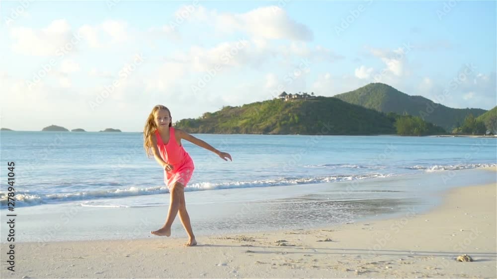 Adorable active little girl at beach during summer vacation Adorable active little girl at beach during summer vacation