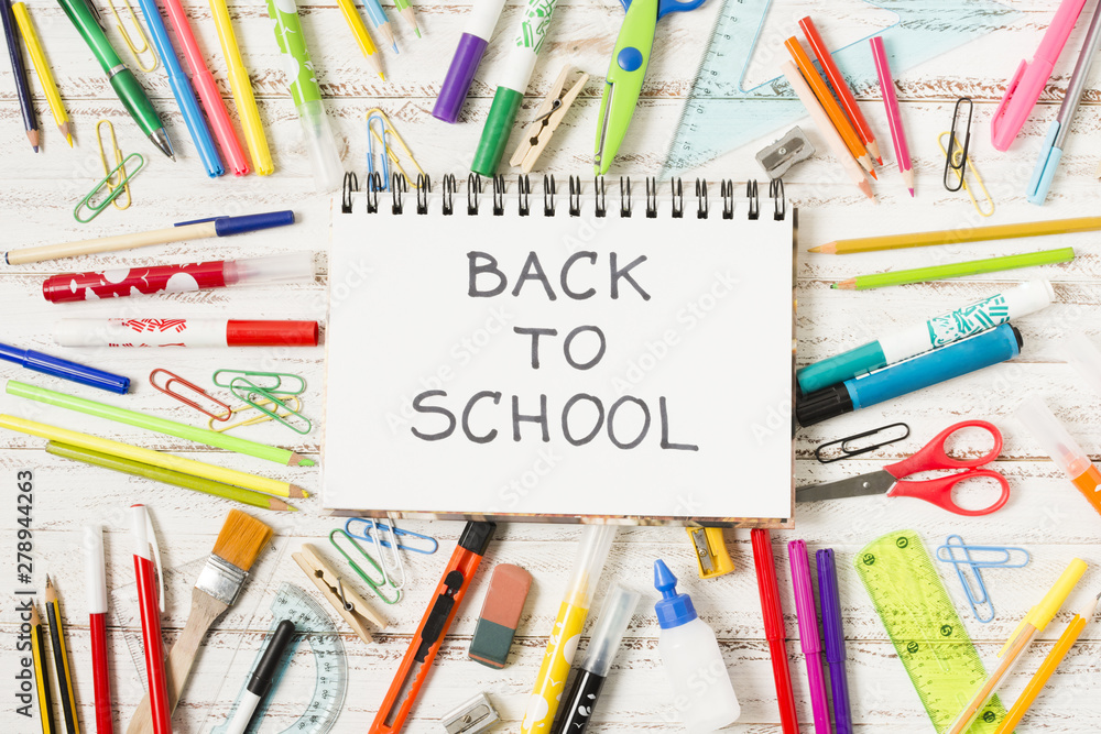 Notepad back to school surrounded by school supplies Notepad back to school surrounded by school supplies