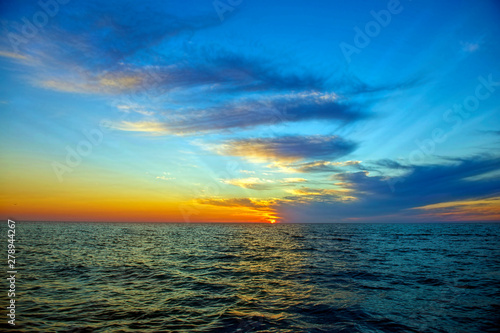 Sun on the Horizon at Sunset over Ocean © David Arment