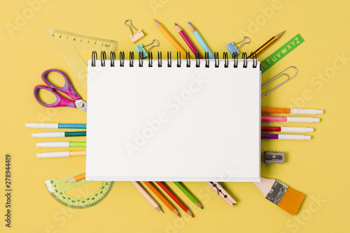 Notepad surrounded by school supplies