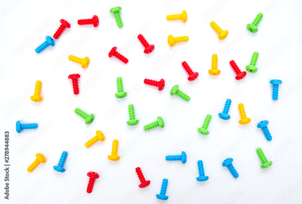 Colorful toy bolts. Construction toys. Background of the screws. Boltiks. Plastic toy Colorful toy bolts. Construction toys. Background of the screws. Boltiks. Plastic toy