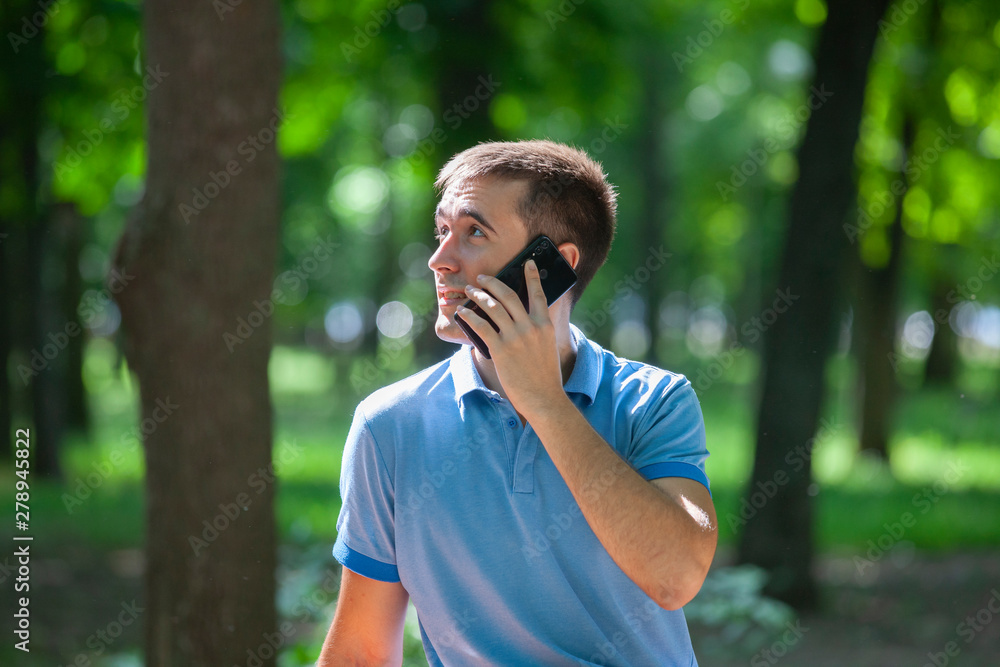 attractive adult man sitting alone on bench in park attractive adult man sitting alone on bench in park