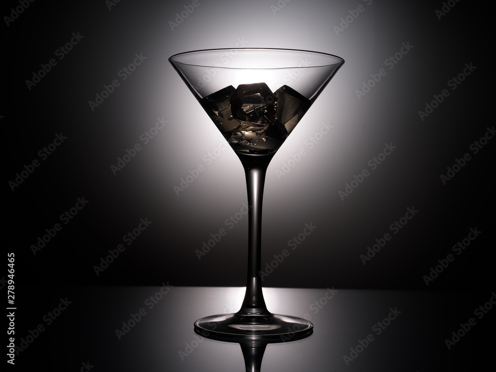 empty martini glass on black background empty martini glass on black background