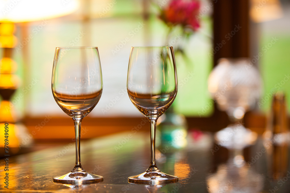 Two empty wine glasses on a bar. Two empty wine glasses on a bar.