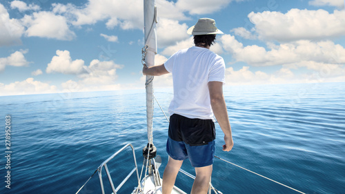 Man standing at the bow of a ship. Yachting, vacation and freedom concept. © TeamDF