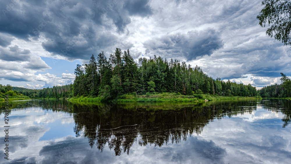 open view to the river of Gauja in Latvia with cloud reflections in water