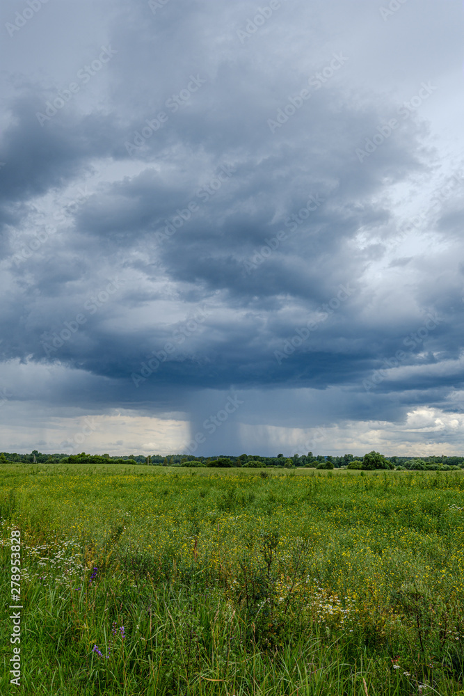 storm rain clouds forming over the countryside fields in green summer storm rain clouds forming over the countryside fields in green summer