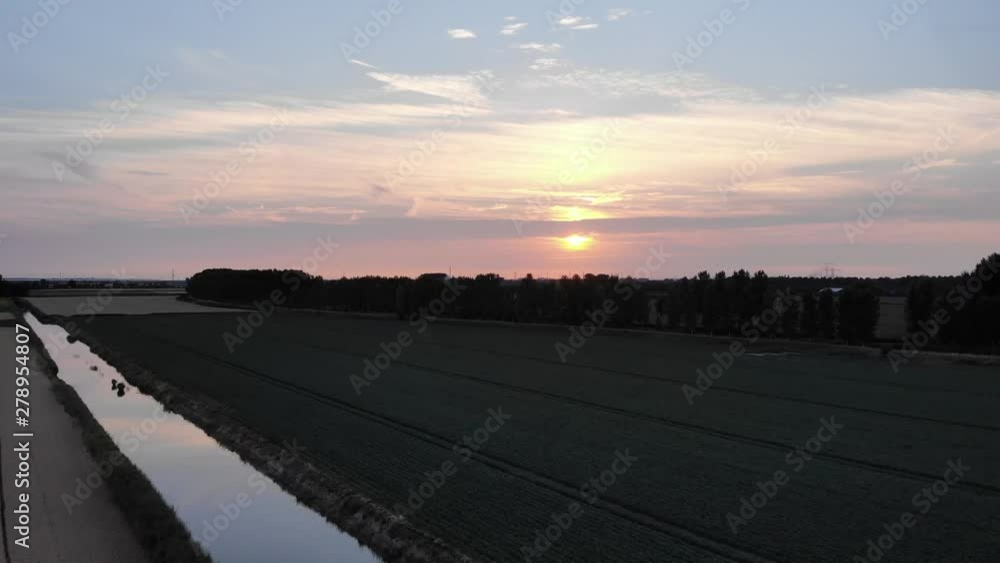 Overview of meadows at sunset in surroundings of 's-Gravenpolder, Zeeland, Netherlands, aerial drone shot in 4K. Overview of meadows at sunset in surroundings of 's-Gravenpolder, Zeeland, Netherlands, aerial drone shot in 4K.