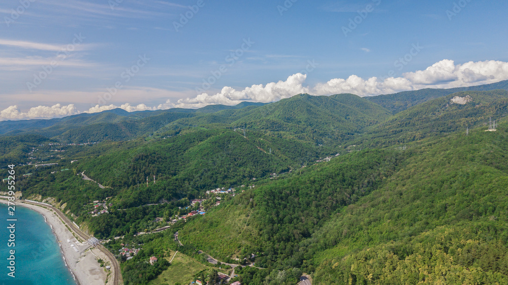 Fototapeta premium Drones Eye View - winding road from the high mountain pass to Sochi, Russia. Great road trip.