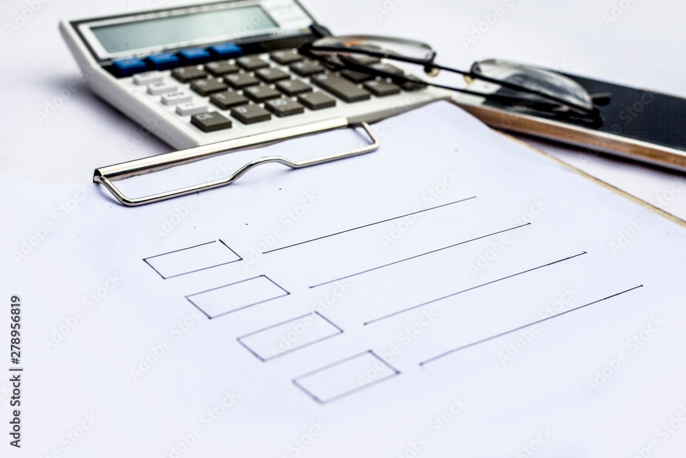 Close up of workplace of businessman or finance consultant isolated on white using credit card, cell phone, pen and calculator like things and some coins also. Close up of workplace of businessman or finance consultant isolated on white using credit card, cell phone, pen and calculator like things and some coins also.