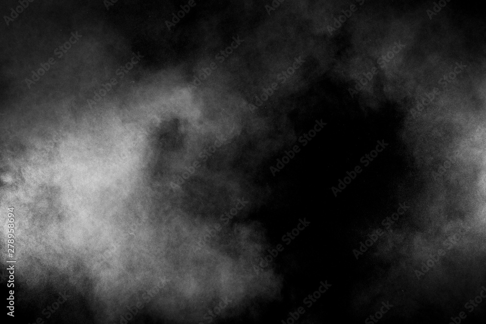 White powder explosion on black background. Abstract white dust texture fly on the air.