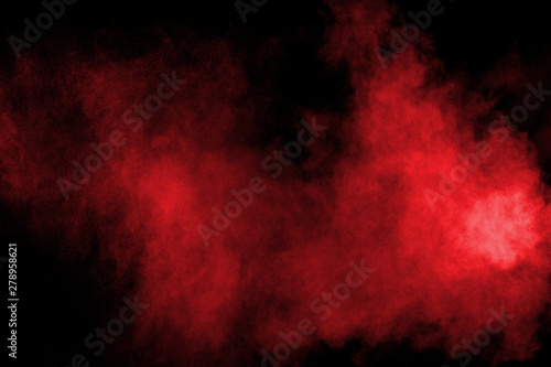 abstract red powder splattered on black background,Freeze motion of red color powder exploding.