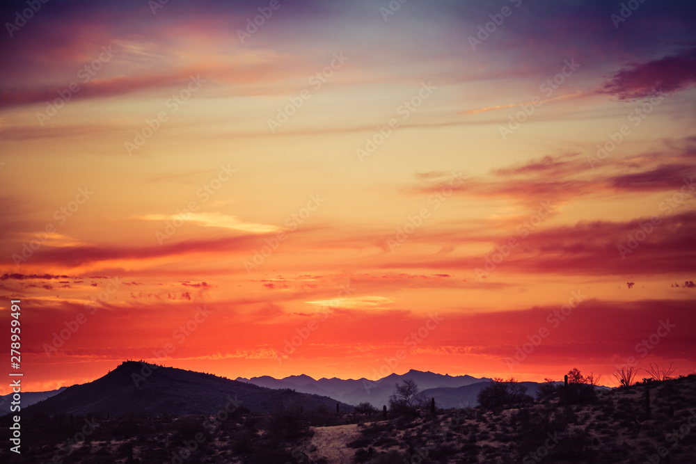 A sunset over a distant mountain in the Sonoran Desert of Arizona A sunset over a distant mountain in the Sonoran Desert of Arizona