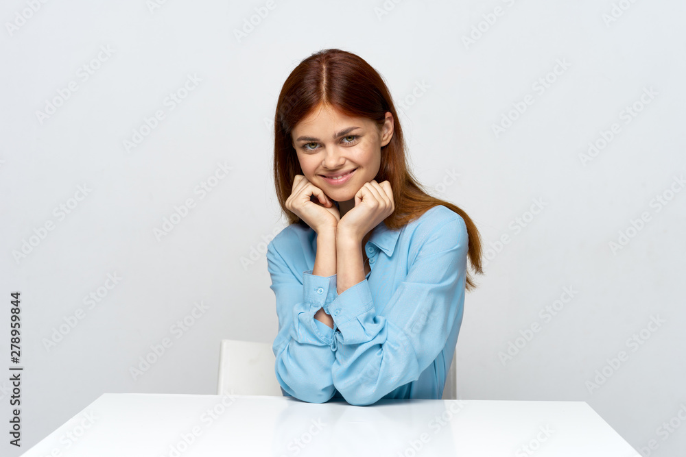 portrait of a young woman sitting at desk portrait of a young woman sitting at desk