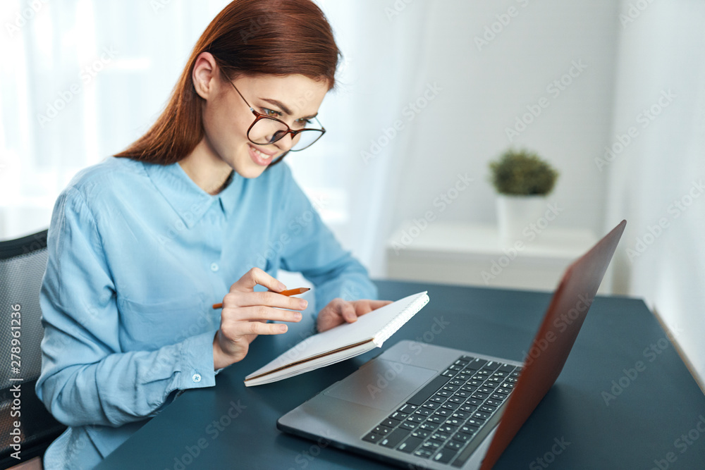 young woman working on laptop in office young woman working on laptop in office